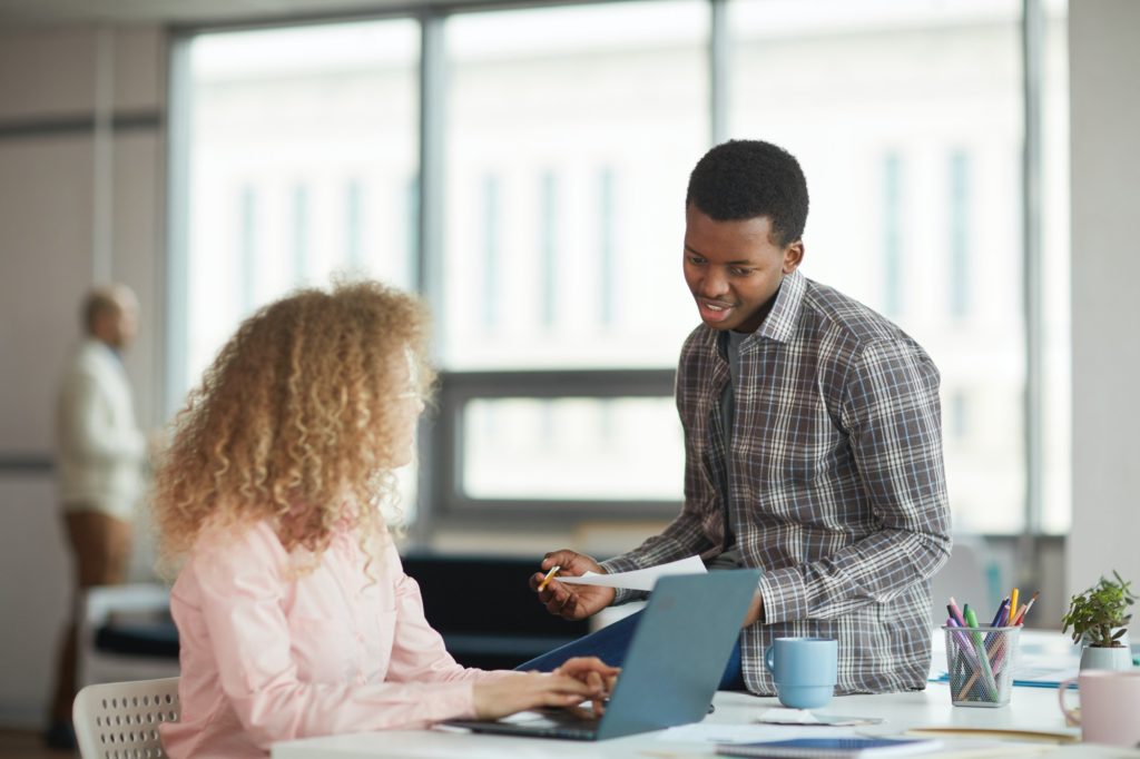 Two Interns Chatting in Office