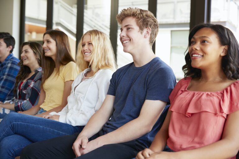 Group Of High School Students Listening To Presentation
