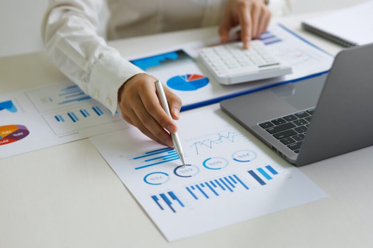 Businesswoman accountant analyze business report graph and finance budget chart in the office.